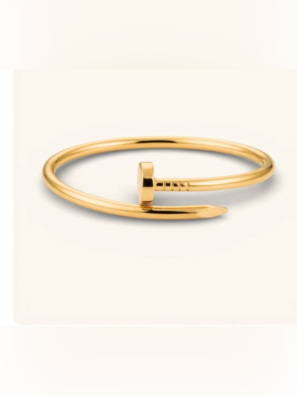 Brand New Elegant gold bangle with nail-inspired design.